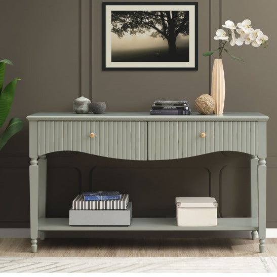 Olive green console table with decorative items against a gray wall.
Olive console by House of Murphy