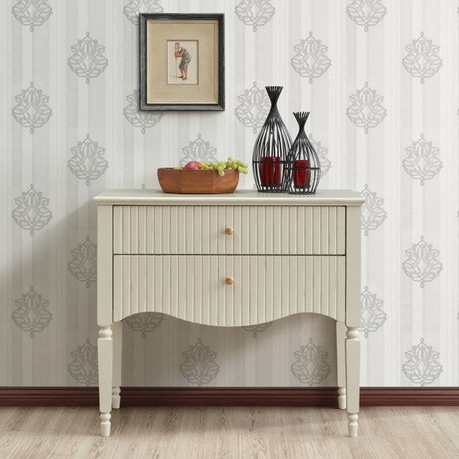Small cabinet with decorative items against a patterned wall. Ritz small console by House of Murphy