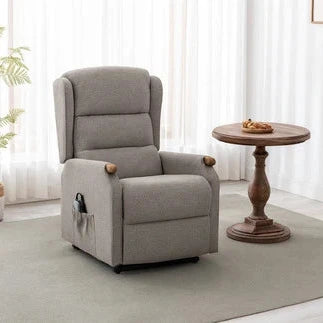 Oatmeal recliner chair in a living room setting with a small table and plant.