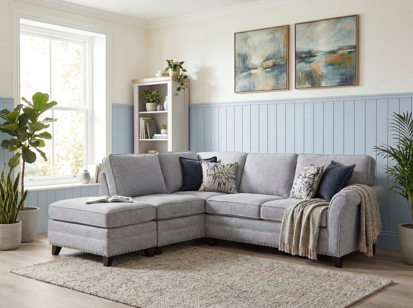A light gray fabric sectional sofa with a chaise lounge, styled in a bright living room with blue paneled walls, decorative pillows, a throw blanket, and a shag rug.
Pippy corner sofa by House of Murphy