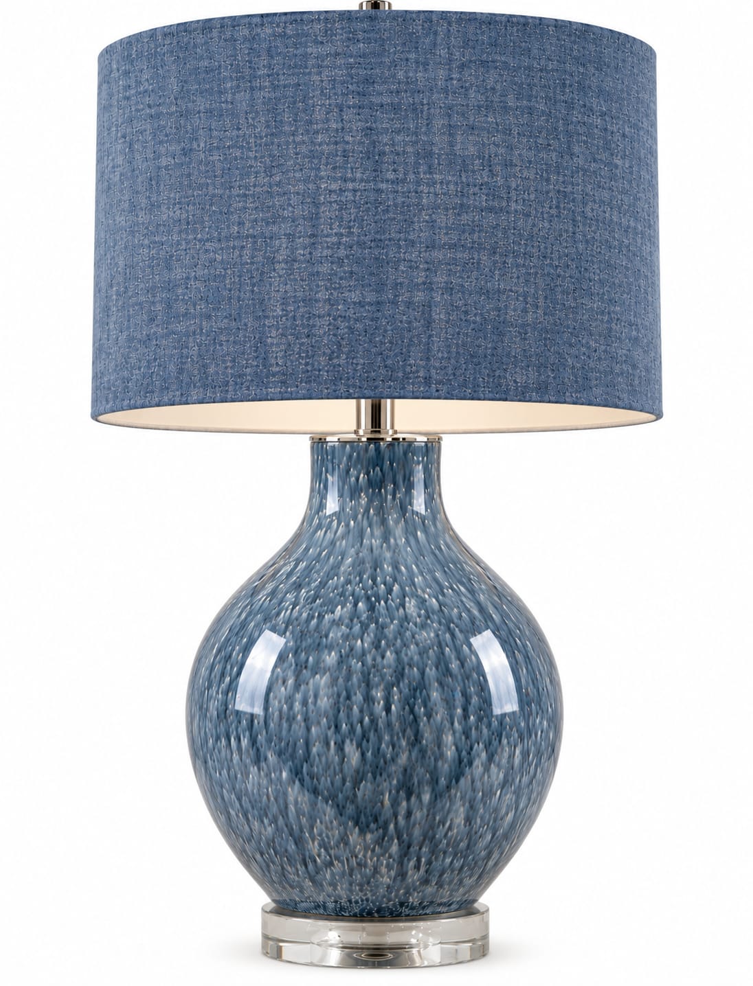 A table lamp with a textured blue fabric drum shade and a glossy blue and white speckled ceramic base on a white background.